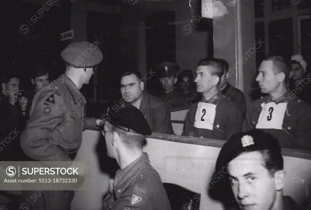 Kramer's defence council, Major T.C.M. Winwood, of reading, who was a London sclicitor before joining the army, speaks to the beast of Belsen, during the first days trial at Luneberg.The first of the war criminal trials to be held in Germany, began on September 17 at Luneburg, when Josef Kramer, "The Beast of Belsen" took his stand in the specially prepared courtroom at Lunenburg, together with 29 men and 19 women who will also be charged with the ill-treatment of allied war prisoners. October 15, 1945. (Photo by Associated Press Photo)