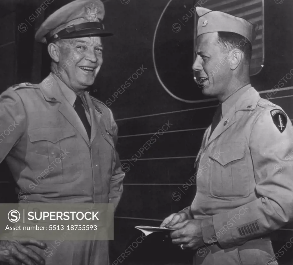 Happy Mood -- Gen. Dwight D. Eisenhower (left) laughs as he talks with an aide. Maj. Craig Cannon, Wilmington, Del., at Union Station today after the army chief of staff disclosed he has accepted the Presidency of Columbia University in New York, effective next year. Gen. Eisenhower was at the station with Mrs. Eisenhower who left for Boone, Ia., and the beside of an aunt who is ill, Miss Edda Carson. June 24, 1947. (Photo by AP Wirephoto).