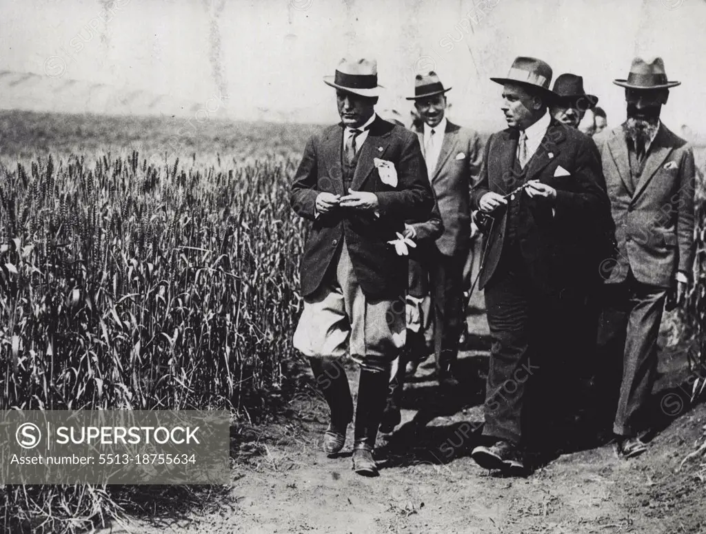 Mussolini The Farmer -- Mussolini with group of experts and members of cabinet making visit to farm country to study crops and farm conditions. June 17, 1929. (Photo by International Newsreel Photo).