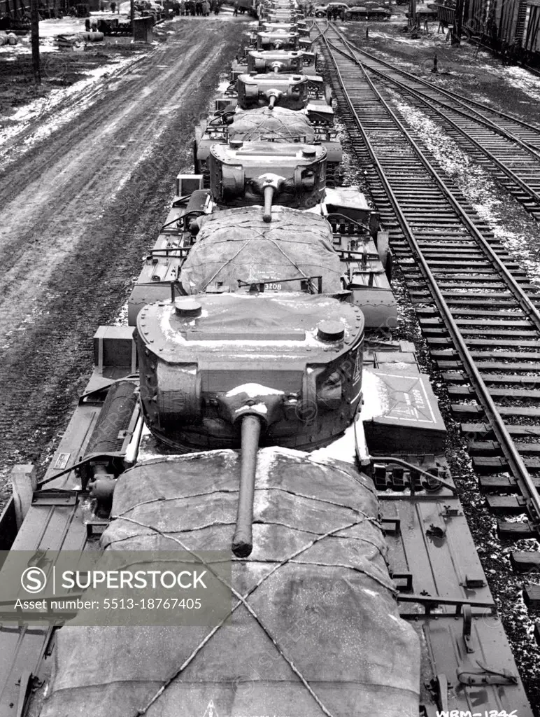 Canadian Tanks bound for Russian Front --  Along line of Canadian-built infantry tanks loaded aboard flat cars leaves the Angus shops in Montreal on the first lap of the long journey to the Russian front where they will help push back the waves of frost bitten Nazis on the Moscow and Southern sectors. One hundred of these infantry tanks will be sent to Russia from Canada. Each weighs 20 tones and has a top speed of 20 miles per hour. More than 3,500 men keep the plant going night and day, Six day a week to keep these steel monsters flowing from the assembly line on a mass production basis. March 22, 1943.