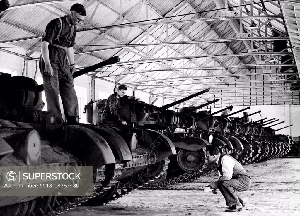 Tank Repair Shops -- Works Foreman makes last inspection of tanks ready for re-entry into service With the tank to battle raging in the East, tank repair and maintenance shops are working at full tempo in his Country to meet the needs of the Eighth Army. At this R.A.O.C. workshop in the south of England, tanks receive speedy attention and are soon in service again. July 2, 1942. (Photo by Fox Photos).