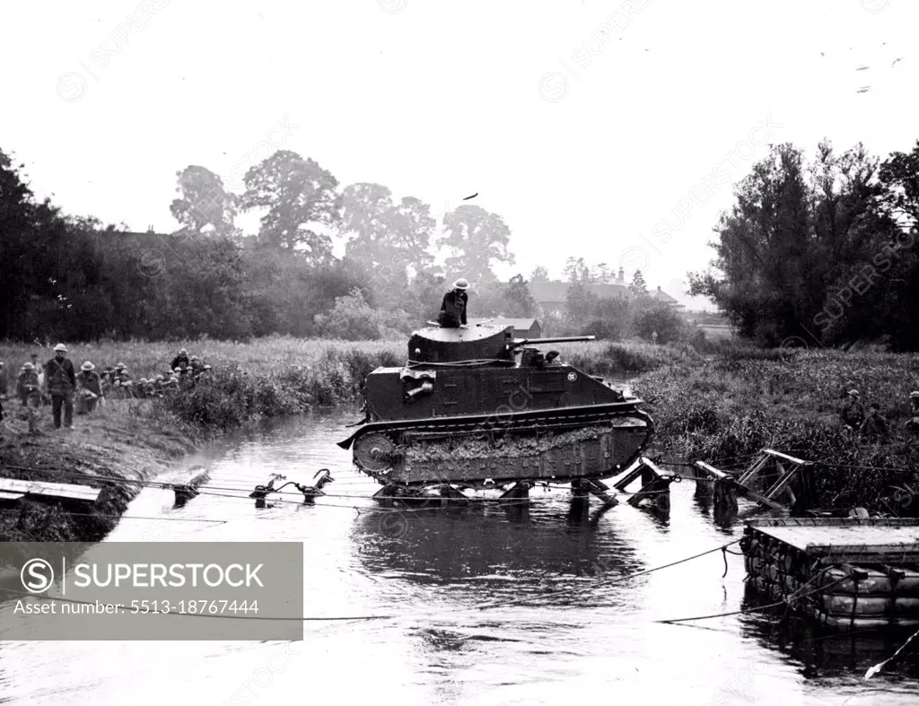 Exclusive Pictures Of Tanquettes Demonstration In Wiltshire -- A heavy tank crossing the River Avon near Amesbury by means of wooden "stepping stones", during the demonstration which was given by the newly Experimental Mechanized Force for the benefit of staff college officers. June 20, 1939. 