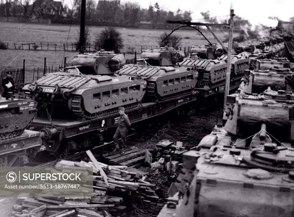 En Route To Meet Hitler's Spring Offensive -- 600 tons of tanks move off for their port of embarkation; they travel past another section of train before being leaded for departure on the next day. Vast supplies of armaments are still pouring out of our factories, for Russia and, thanks to the convey system,are reaching their destination. These tanks are leaving a large ordnance Depot somewhere in Russia". April 9, 1942. (Photo by Fox Photos).