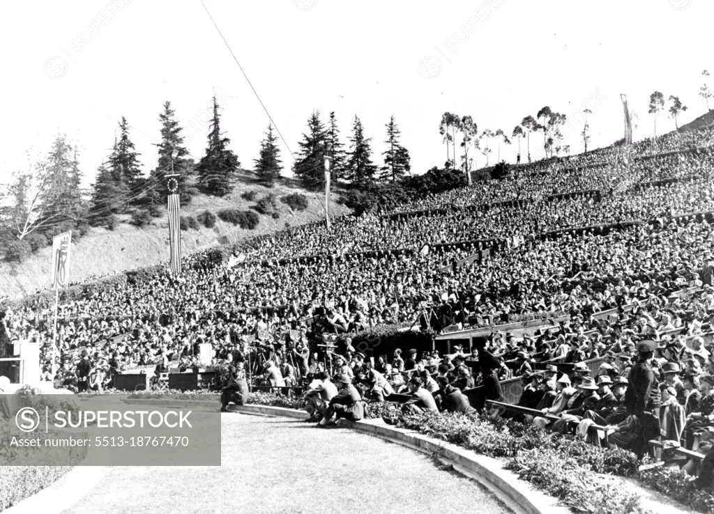 Madame Chiang Kai-Shek Addresses 30,000 Persons In Hollywood Bowl -- Madame Chiang Kai-Shek, wife of the Generalissime of China, is shown at the left addressing the largest audience of her tour of the United States in Hollywood, American movie center. An audience of 30,000 men and women filled Hollywood Bowl to capacity to hear her pledge that China would fight until final victory is won and then play its port in a just and lasting peace. June 21, 1943. (Photo by Office Of War Information).