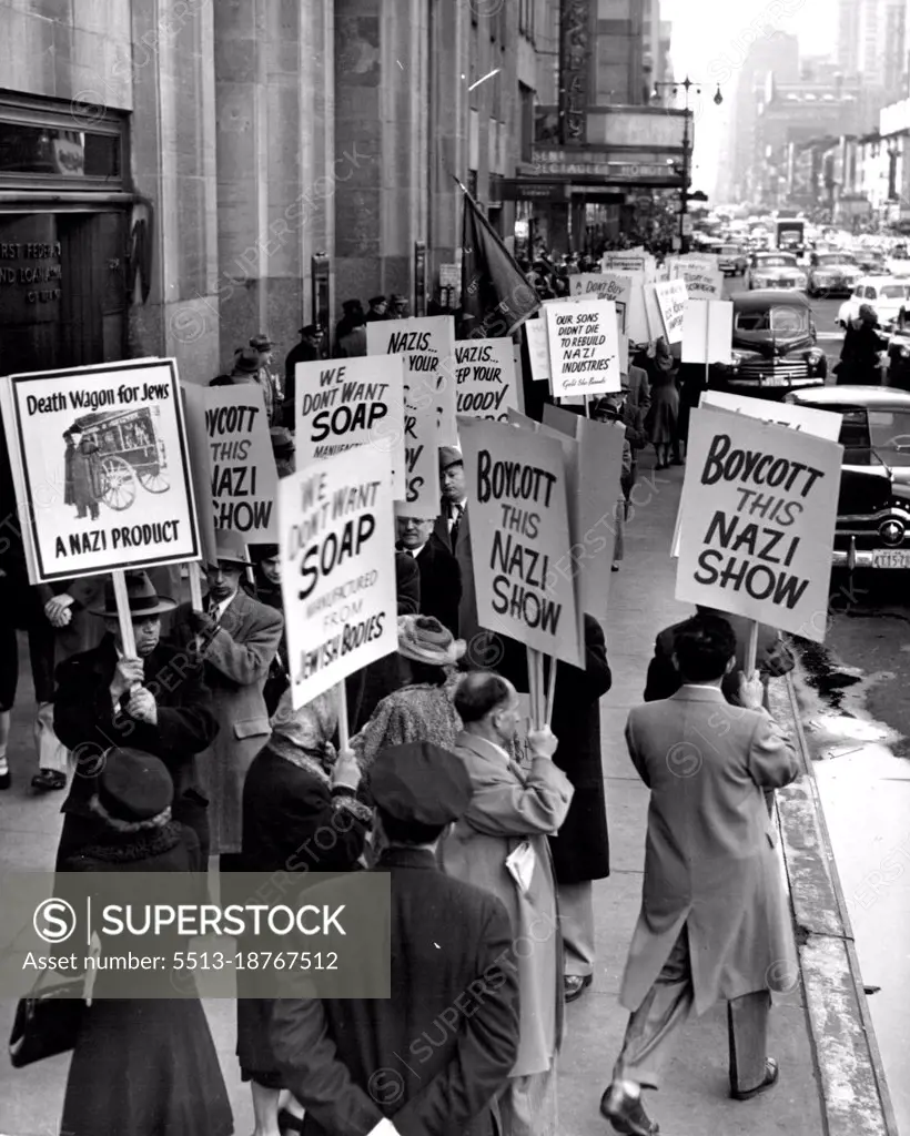 Protest German Industrial Exhibit - Pickets parade past the entrance to the Museum of Science and Industry in Rockefeller Center, New York City, April 9, in protest to the opening there of the Military government German Industrial Exhibition. Pickets are representatives of the Joint Committee to Combat Anti-Semitism which contends that the show indicates a re-Nazifying of Germany. April 09, 1949. (Photo by Associated Press Photo).