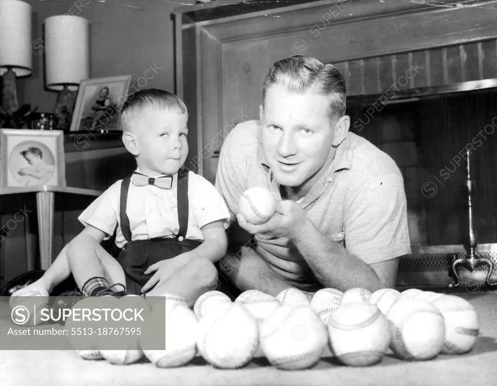 Marbles -- A La Whitey Ford -- Using Baseballs in a novel game of Marbles, pitcher Whitey Ford plays with his two-year-old son, Eddie, at the Ballplayer's Glen Cove, L.I., Home. Ford recently returned from an Exhibition tour of Japan with his fellow New York Yankees. How can you miss with big "Marbles" Like Those August 12, 1955. (Photo by United Press Photo).