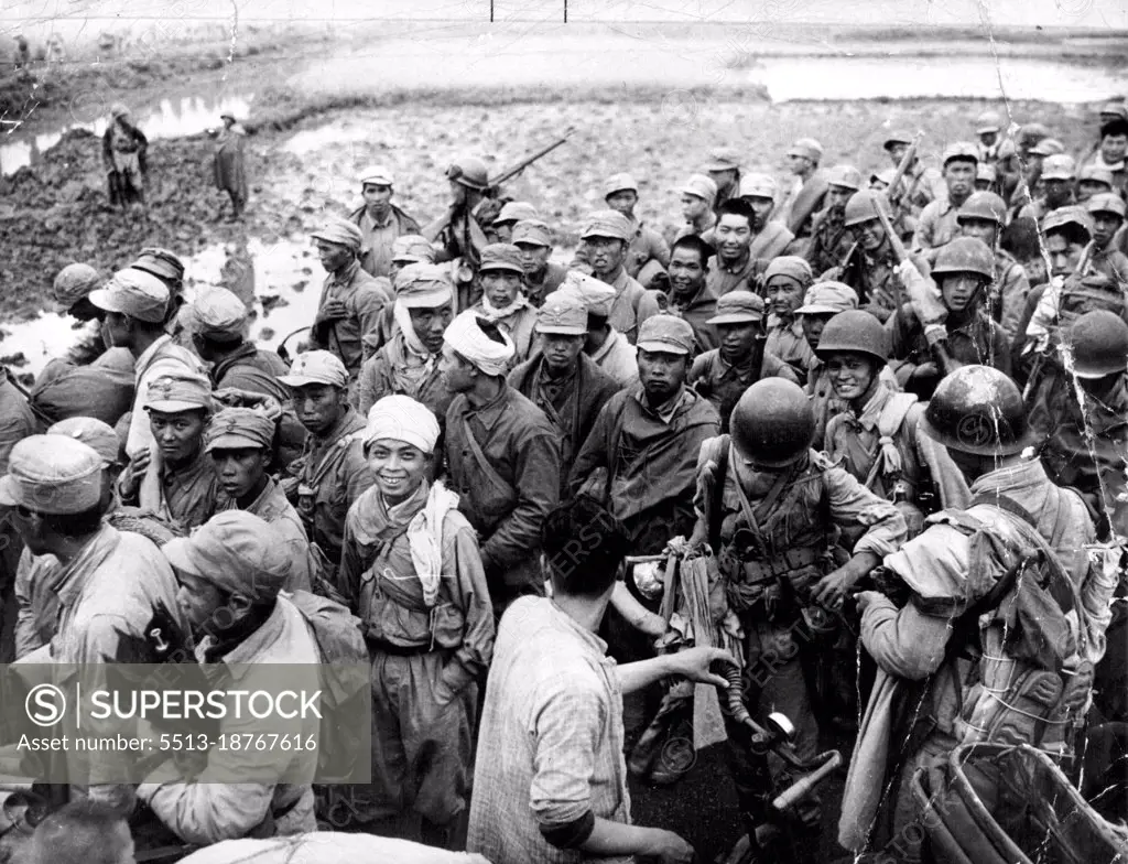 Captives Of Chinese Communists -- Nationalist troops captured in the fighting at Woosung, China, 10 miles North of Shanghai, are herded toward prisoner of war camps by Red guards (wearing helmets). June 17, 1949. (Photo by Associated Press Photo).