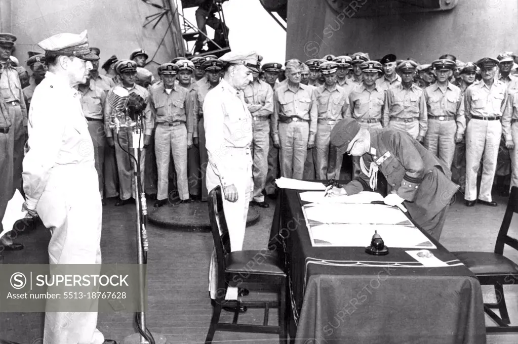 Japanese General Signs Unconditional Surrender Documents -- Japanese General Yoshijiro Umezu, Chief of the Imperial General Staff, signs Japan's surrender documents in the presence of U.S. Lieutenant General Richard K. Sutherland (center), Chief of Staff to U.S. General of the Army Douglas MacArthur (behind microphones), Supreme Allied Commander, and other Allied military officers. The capitulation ceremonies took place aboard the U.S. battleship Missouri in Tokyo Bay, south of the Japanese capital, on Sept. 1, 1945. June 9, 1945.