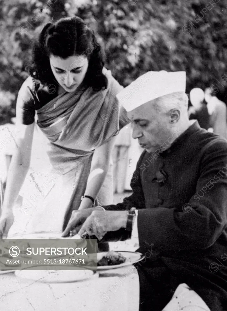 Mrs. Indira Gandhi & Family -- Mrs. Indira Gandhi makes it a point to serve food to her father herself. May 08, 1954. 