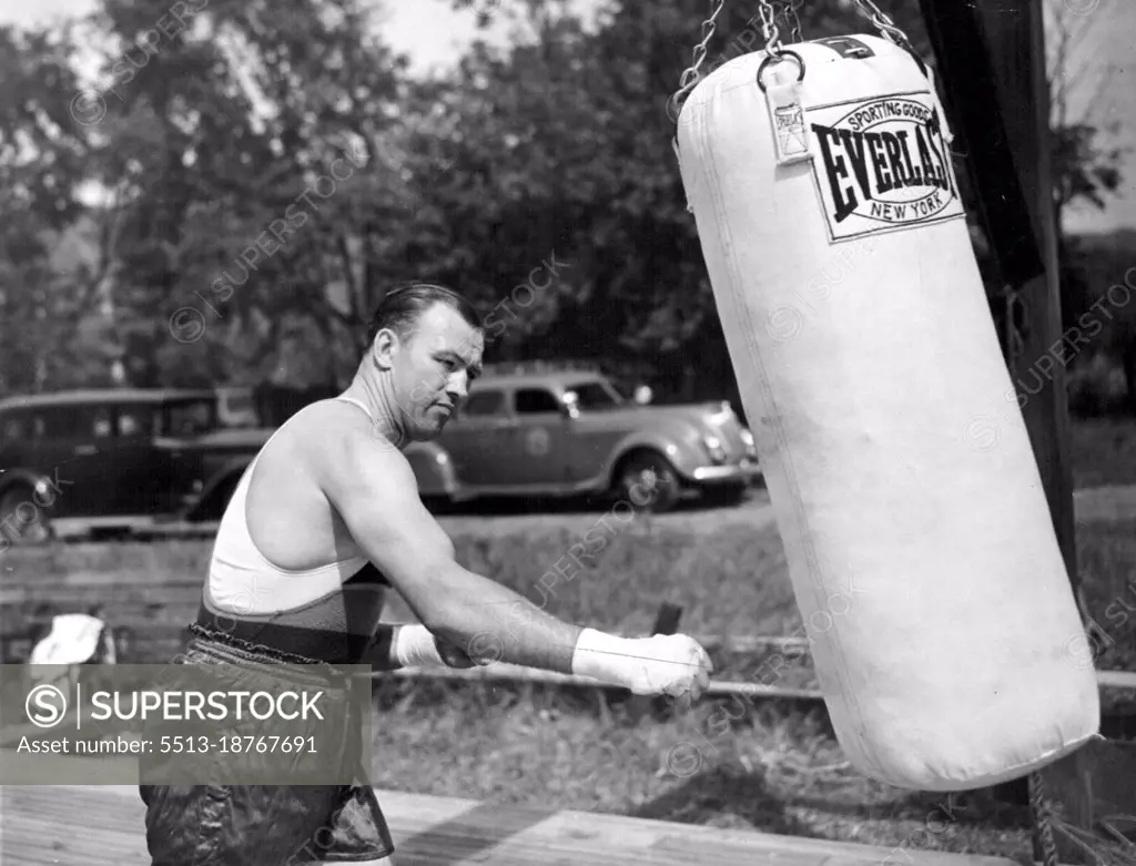 Sharkey Punches The BagJack Sharkey shown punching the heavy sand bag at his training camp here today as he began his workouts preparatory to his heavyweight fight with Joe Louis. February 17, 1953. (Photo by Associated Press Photo).