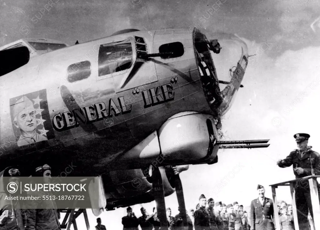 Gen. Eisenhower Names The "General 'Ike'"Gen. Dwight D. Eisenhower (right) christens the flying fortress "General ' Ike'" at a U.S. heavy bomber station in England by smashing a bottle of Mississippi river water against the baffels of the ship's. 50 caliber guns. April 18, 1944. (Photo by Associated Press Photo).