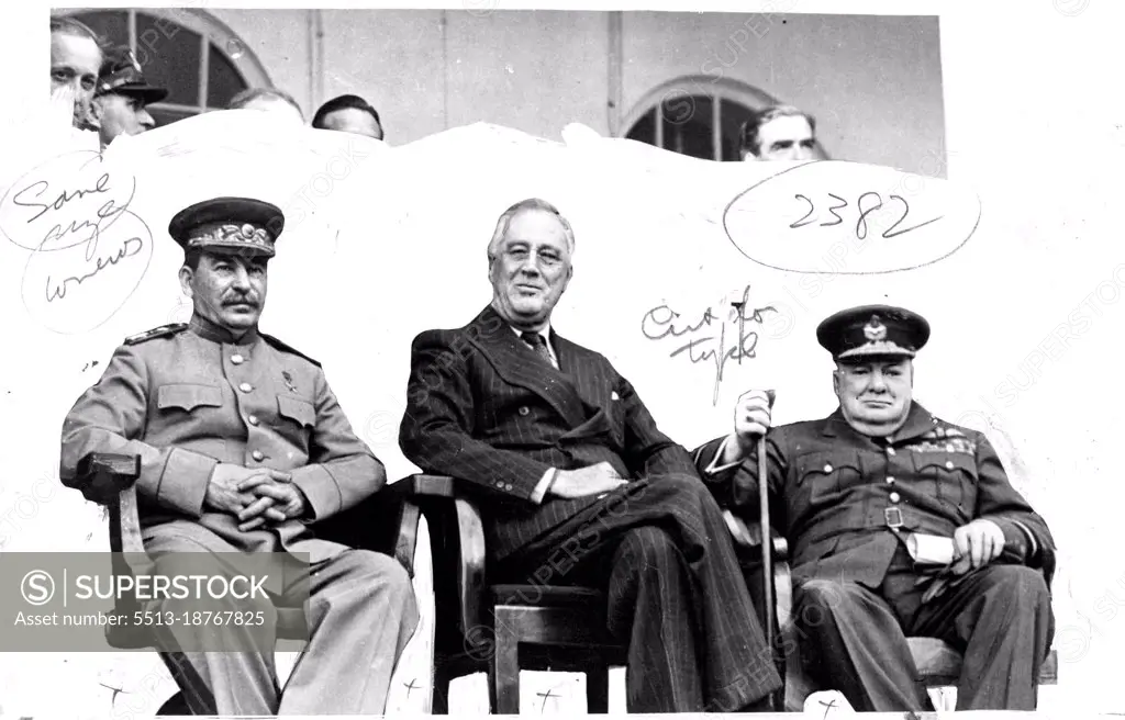 'We three" -- Marshal Stalin, President Roosevelt and Mr Churchill at their meeting in Teheran, the Capital of Persia.With them at back can be seem:- Mr. Molotov, Mr. Antony Eden and Section Officer Mrs Oliver, daughter of Mr Churchill. February 22, 1944. (Photo by L.N.A.).