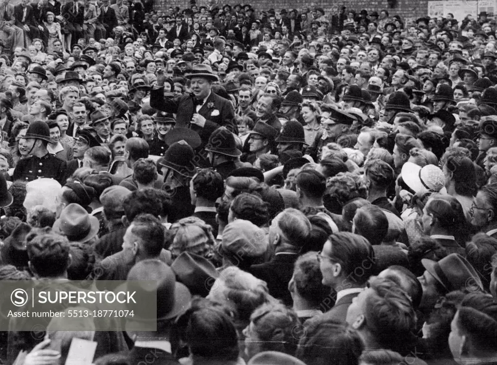 Churchill Hailed On Election Tour -- The Prime Minister stands in the leading car of a long procession passing through densely-crowded/Trinity-street, in blitzed Coventry, where he received a great ovation from the people. Making a ten-speeches-a-day election tour, Mr. Churchill, Conservative leader, ended the first day in the Midlands tired but triumphant, his campaign taking on the appearance of a victory celebration, with men and women of all political parties thronging the route to cheer the leader of the Coalition Government which led Britain to victory in Europe. June 26, 1945. 