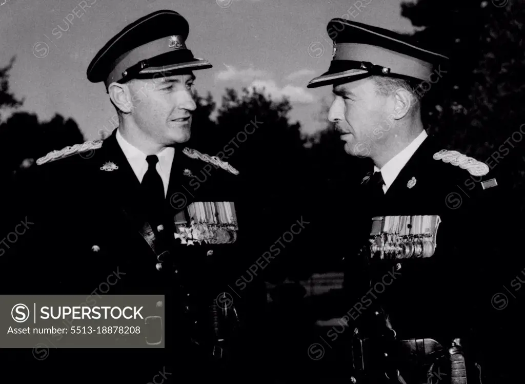 Two ex Commanding Officers of 3 Battalion R.A..R. chat over the Korean "SHO" after the presentation of trophies to Kapyong Company Royal Military ***** Duntroon. They are L to R. Lt-col. J Hassett and Lt-col. I.B.Ferguson who was commanding Officer of the Battalion when it won the U.S. *****  Citation at the historic battle of Kapyong. Lt. Col. Ferguson presented a ***** copy of the citation to Kapyong Company of the RMC at Duntroon yesterday Thursday afternoon. October 11, 1954.