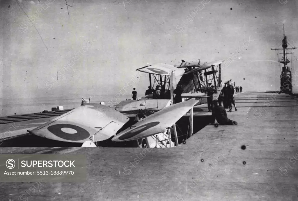 Navy's Pocket Carrier Beats U-Boat Packs - A Swordfish going down the lift of one of Britain's latest escort carriers. A second aircraft in charge of its crew is waiting. Note the extreme narrowness of the bridge, from which the ship is controlled on the right-hand side of the deck.Aboard one of the Navy's latest "pocket" escort carriers, which are proving such an effective counter weapon to the U-Boat pack. October 25, 1943. (Photo by British Official Photograph).