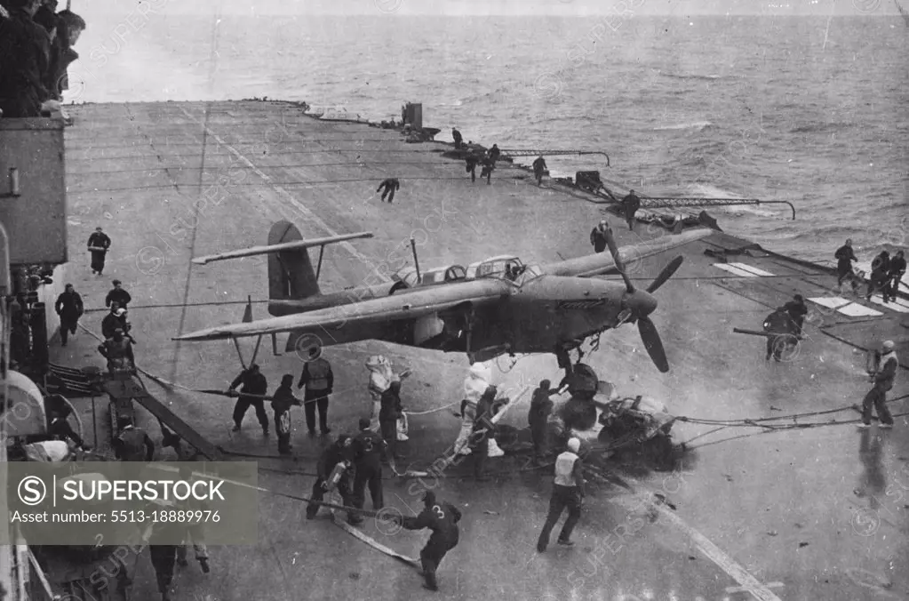 Fleet Air Arm Strikes The "Tirpitz" - A "Barracuda" on fire from enemy flak lands on the flight dock, while the fire party dash into action.On board a Royal Naval aircraft carrier during another successful operation against the German battleship "Tirpitz" and enemy shipping off Norway. September 01, 1944. (Photo by British Official Photograph).