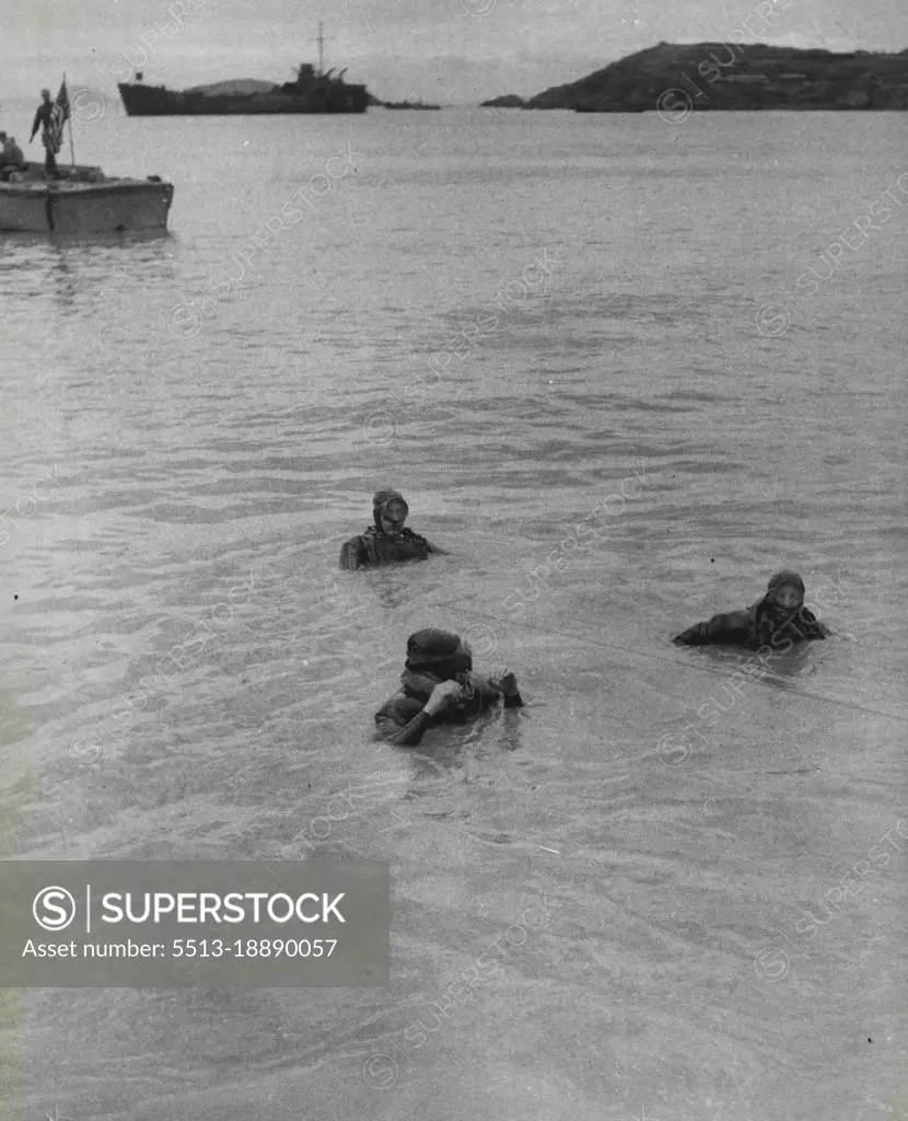 The Uprooted -- "Frogmen" of the underwater demolition teams of the U.S. 7th Fleet perform their duties in a "Scorched Earth" plan. They destroyed harbour facilities as well as onshore installations that might have been of use to the Chinese Communists. February 18, 1955. (Photo by United Press).