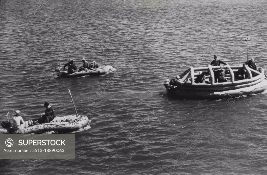 Experimental Raft Which Had To Burned -- The 20-man experimental life raft, dubbed "the covered wagon," proceeds towards Ludington, Mich., at the head of flotilla of 11 rafts like the one at left off Sheboygan toward Ludington, across Lake Michigan. The army said the crossing was a success but that the "covered wagon" (right) had to be burned 20 miles off Ludington as a "navigational hazard". July 21, 1947. (Photo by AP Wirephoto).