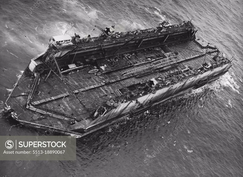 Bermuda Floating Dock Nears Britain -- Aerial view of the floating dock in the Atlantic Ocean, 400 miles off the English Coast.The largest "Chunk" of H.M.S. Malabar, the Navy's name for its Bermuda Dockyard which was closed last March, is being brought back to Britain. Last evening, Aug. 7, it was sighted 400 miles off the English Coast, heading for Falmouth.This huge floating dock is capable of taking up to 14,000 tons of shipping at a time. Its sea trip of 2,500 miles, begun early in July, was an operation undertaken by there of the Navy's most powerful tugs, H.M. Tugs "Reward", "Warden" and "Prosperous". August 08, 1951. (Photo by Paul Popper, Paul Popper Ltd.).