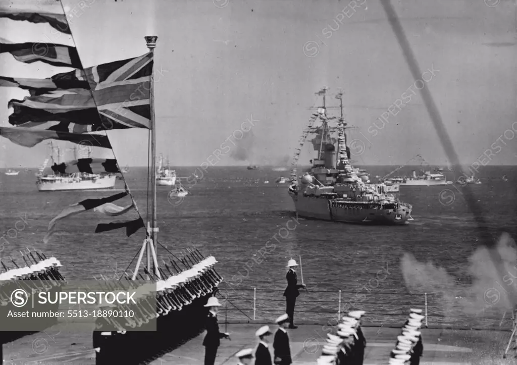 Soviet Ship Salutes The Queen - The Russian cruiser Sverdlov fires a salute during the Review of the fleet by the Queen at Spithead this afternoon.This picture was made from the aircraft carrier H.M.S. Implacable. June 15, 1953. (Photo by Planet News Ltd.).