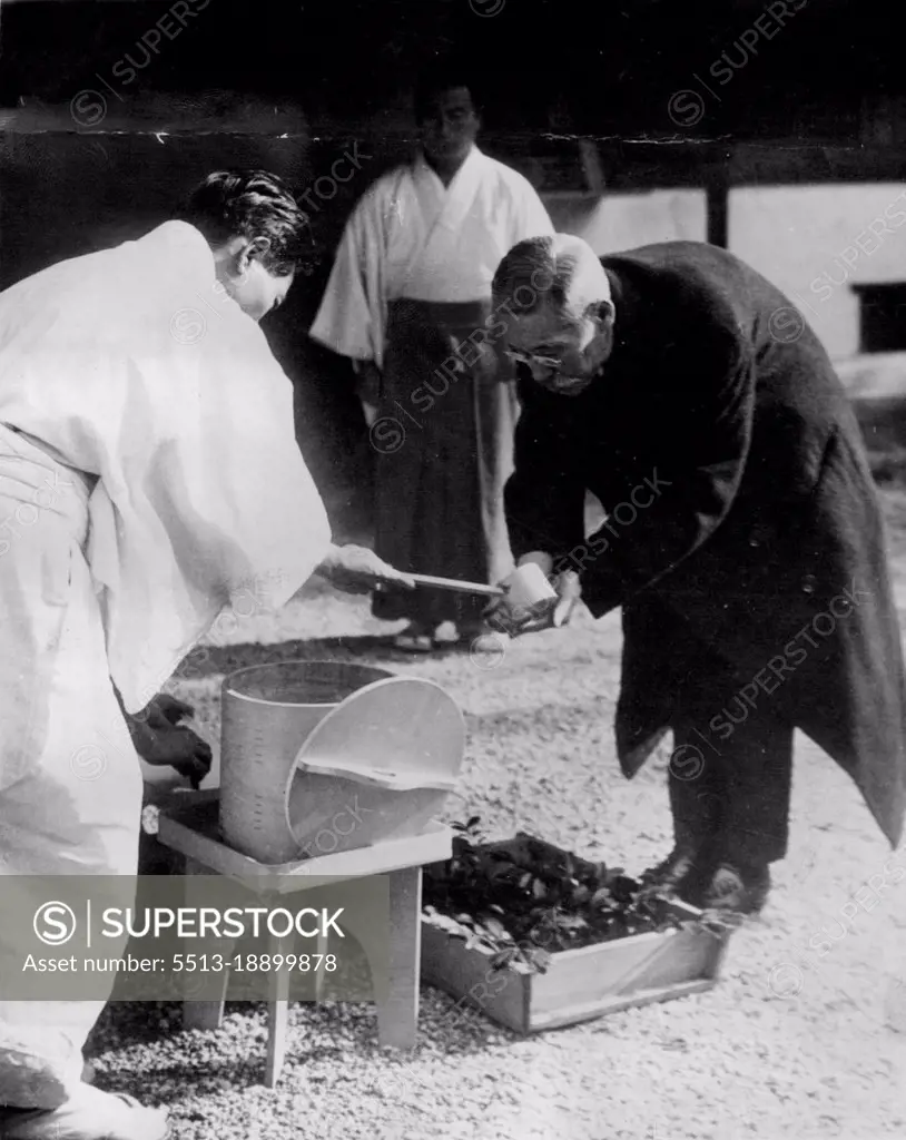 Japan New Prime Minister Purifies Hands Before Informing Ancestors -- Baron Kiichiro Hiranuma, Japans New Prime Minister, Purifies his hands before entering a shrine to "Report" to his ancestors that he has taken over the leadership of the Government. February 20, 1939. (Photo by Associated Press Photo).