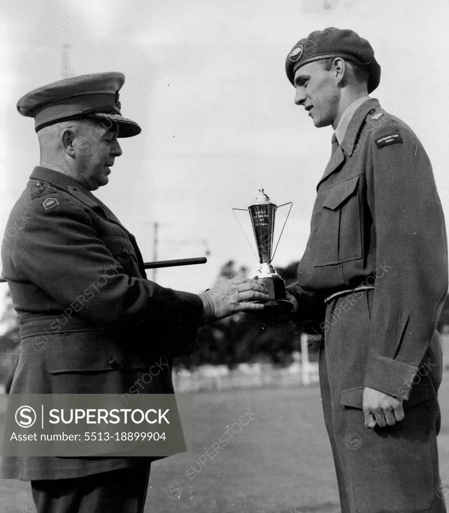 Ceremonial Parade of the Marist brothers high school Darlinghurst this shot shows the Brig F. Hinton. old boy of the school presenting his cup to the winner of the best shooting cadet in the school Corp. Cadet Lt. R. Byrne of Darlinghurst at the Rushcutter bay oval during the passing out parade. October 9, 1952. (Photo by Gordon Herbert Short/Fairfax Media).