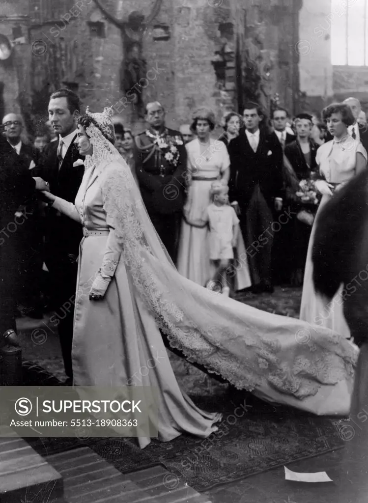 Royalty Weds: Prince Ernst August Von Hanover and Princess Ortrud Zu Schleswig-Hostein Sonderburg-Gluecksburg stand before the altar in the market church during their church wedding ceremony. In background (center), wearing uniform, is King Paul of Greece. September 6, 1951.