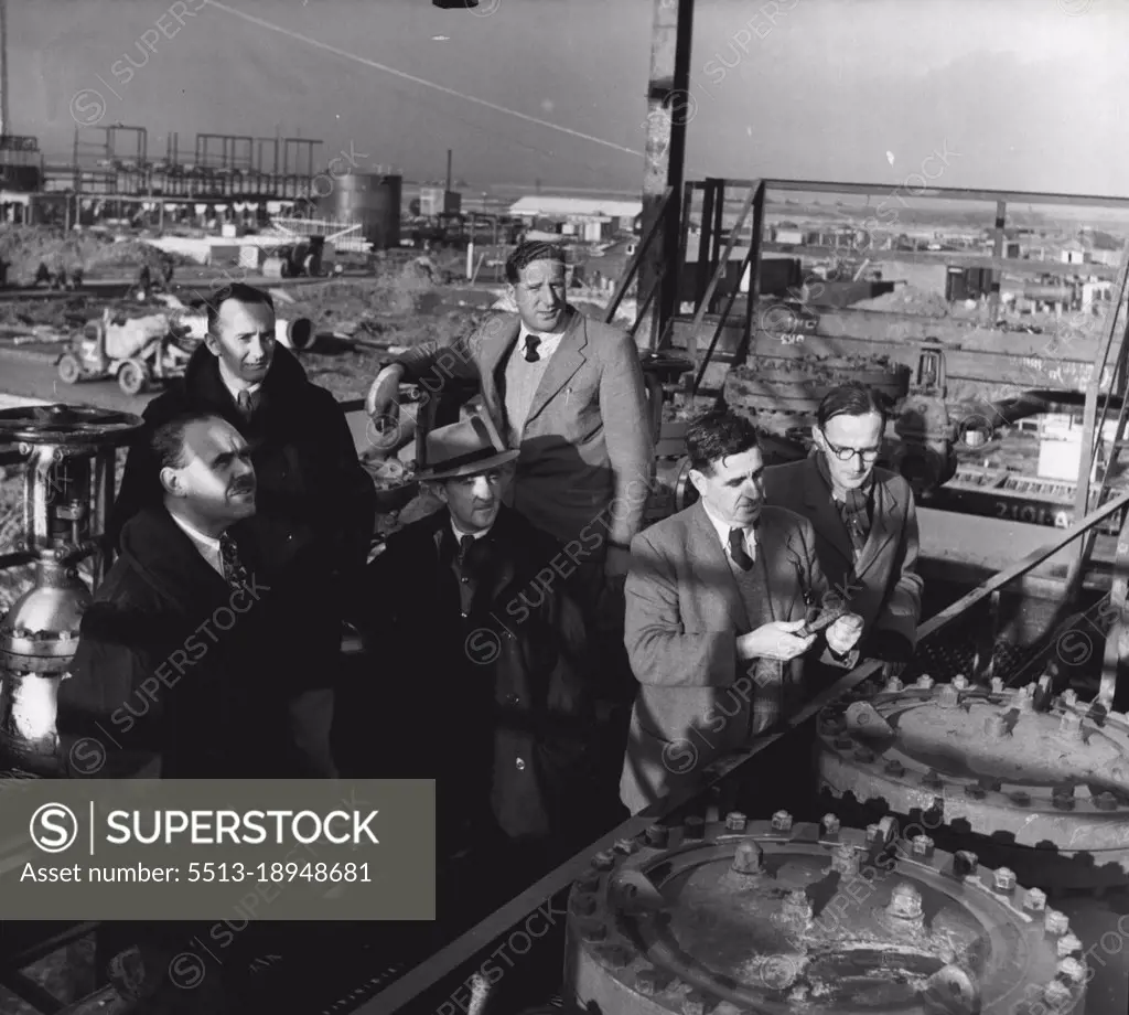 The Men From Abadan - Six of the six of the men who came back from Abadan are now using their accumulated experience In the building of the Kent Refinery which is planned to he the biggest and most productive anywhere in the world outside the USA. The men are here seen jointly inspecting one of the recently completed structures, Vacuum Unit Bomber One. February 8, 1952. (Photo by Tom Blau, Camera Press).