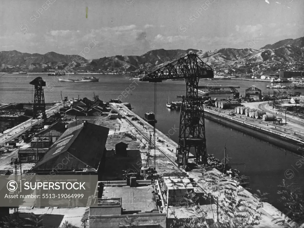 Kure Harbour, Japan -- One of the Japan's former key naval bases are at present base of all British forces in Japan. Land seen in the distance is Hiroshima prefecture. July 1, 1953. (Photo by Camera Press).