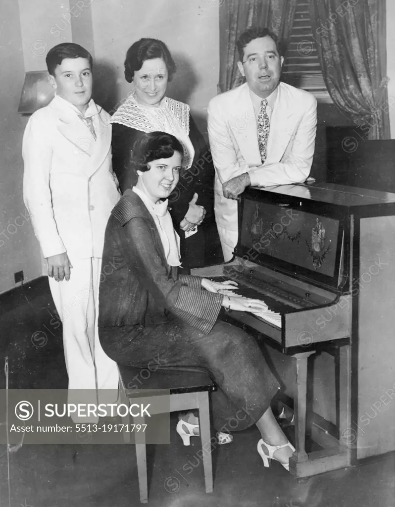 Then the Longs Visited New York -- New York-here's the family of Senator Huey P. Long of Louisiana, photographed when they visited here July 25, and the senator took time out to show the town how to make a Gin Fizz. At the Piano is daughter Rose; in back, left to right, Palmer Long, Mrs. Long and the "Kingfish," who was shot and seriously wounded in the Baton Rouge, La., state house September 8. September 9, 1935. (Photo by Associated Press Photo).