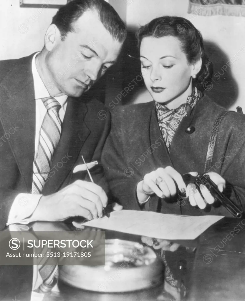 Hedy And Mate Seek Gun Permit -- Actress Hedy Lamarr holds a revolver as her husband, John Loder, signs an application for a gun permit at police head quarters today. Their home was burglarized the other night of $18,400 in furs and Jewelry.Film Stars Hedy Lamarr and husband John Loder recently signed an, application for a revolver permit after their home had been burgled. Hedy Lamarr holding the revolver. Burglars took furs, jewelry, and 18,400 dollars. April 19, 1946. (Photo by AP Wirephoto).