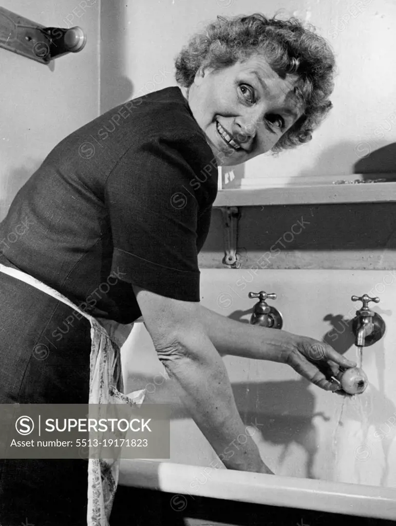 Mrs. Henry Cabot Lodge wears dress with flower-seed package designs as she cuts green peppers. September 22, 1947.