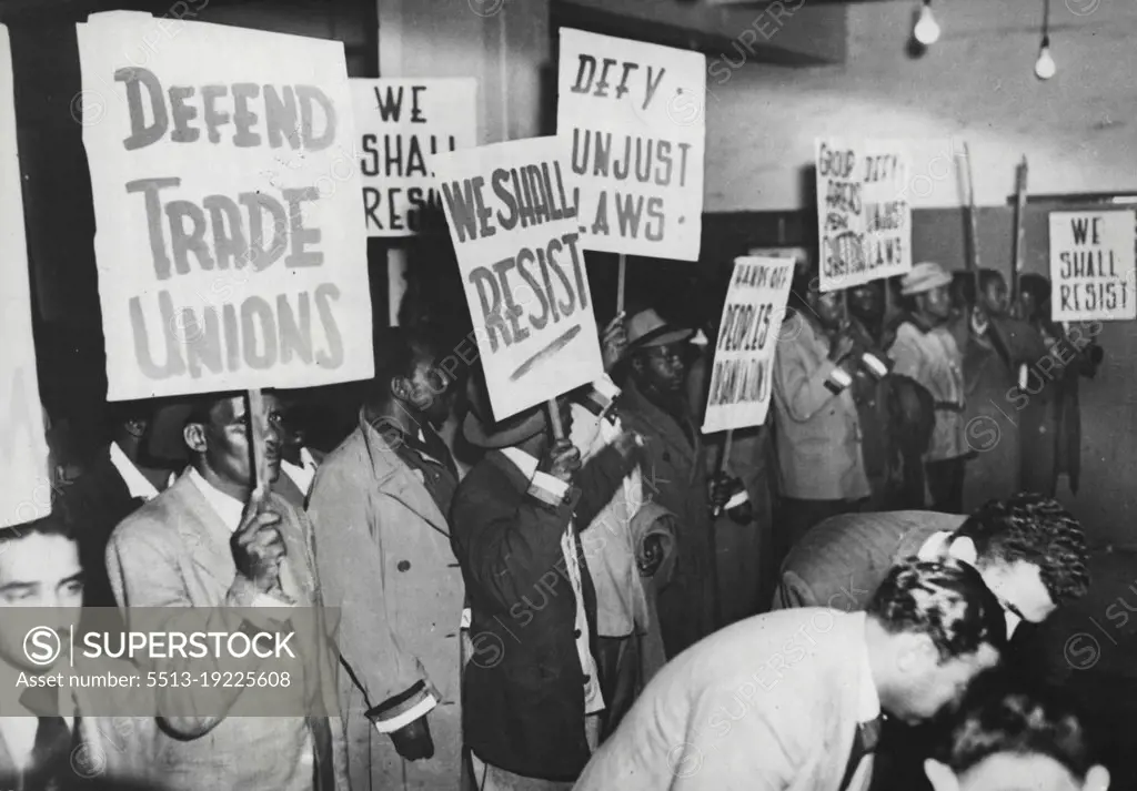 Passive Resistance Marchers In Johannesburg -- "Volunteers," with their banners proclaiming resistance to racial discrimination laws and anti-trade union action; assemble in Anderson Street, Johannesburg, for a curfew-breaking march on the City Hall.The march was part of the passive resistance campaign conducted by non-Europeans against racial segregation in the Union.More than 2,000 people have already been arrested, according to one campaign leader. September 29, 1952. (Photo by Reuterphoto).