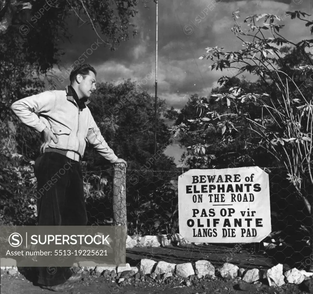 Kruger Nat. Park - A visitor from Sheffield, England, John Jeffcock, stands by the notice warning him of elephants he might meet on the road. November 25, 1948. (Photo by George Rodger, Magnum).