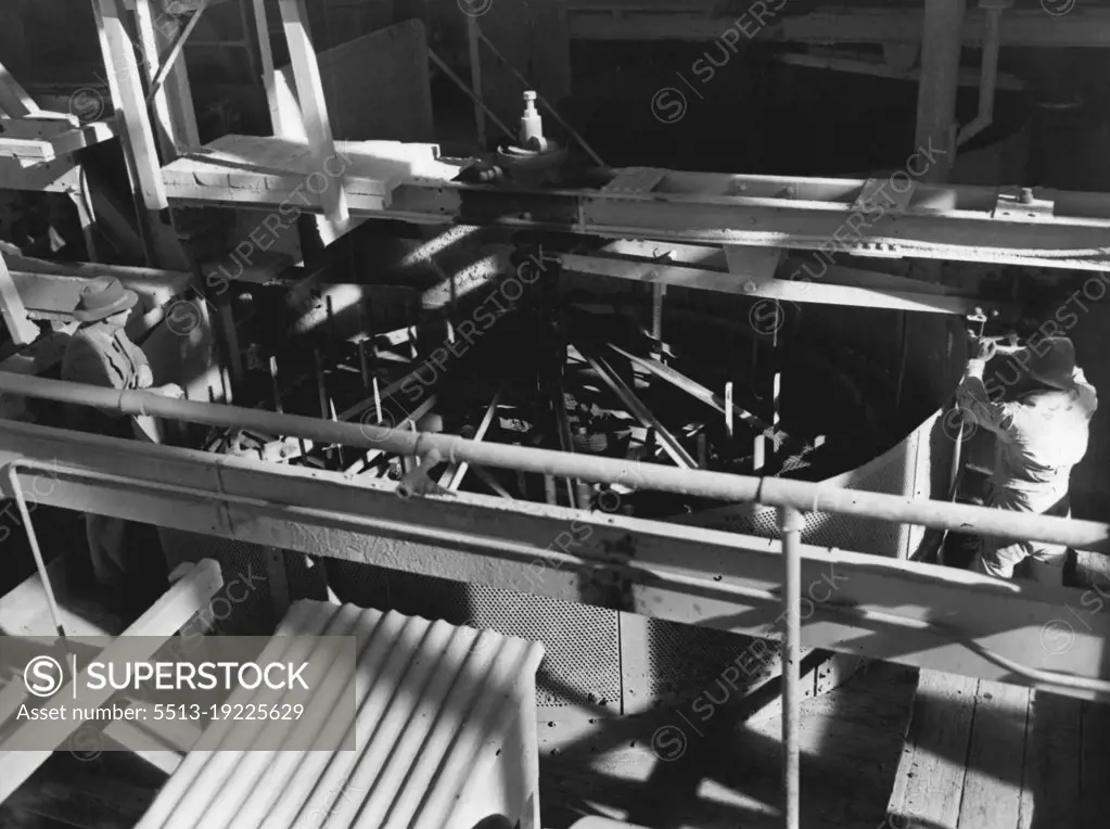 A giant rotating washing machine at the De Beers Diamond mines, Kimberley. Thousands of tons of gravel and water are fed into this machine daily, and once the scum, dirt and sludge are washed away the clean gravel is tapped, and allowed to run onto a table which has been specially constructed to retain diamonds. October 10, 1952.