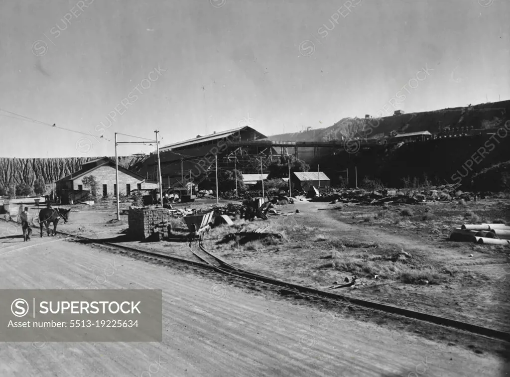 A view of a section of the De Beers diamond mines at Kimberley, S. Africa. In the background are low hills of exhausted "Blue Gravel" taken from the Big Hole, the Du Toitspan workings and other mines. This "Blue Gravel" yielded some of the purest diamonds found in any part of the world. October 10, 1952.