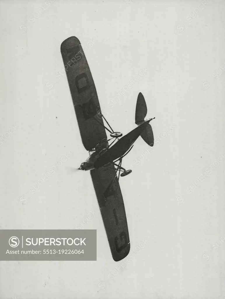 Zooming Over The Aerodrome -- Apparently its crash in Siam has not affected Captain Matthews' machine. Its is here shown zooming over the crowd at the Eagle Farm aerodrome. January 20, 1931. (Photo by Brisbane Daily Mail Ltd.).