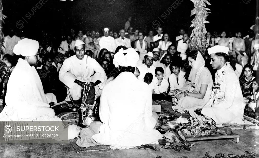 Nehru's Niece Married -- The Bride and Bridegroom (right), Garlanded with flowers and Jewels, make their pledge before Agni (fire) during their marriage ceremony.Chandralekha Pandit, daughter of Mrs. Vijaya Lakshmi Pandit, and Niece of Prime Minister of India Pandit Nehru, was married to Mr. Ashok Mehta, Indian Consul-General in Saigon, at New Delhi, India, April 14. The marriage ceremony was attended by the Governor General of India, members of the Cabinet, The Diplomatic Corps, and other distinguished personalities. May 01, 1949. (Photo by Associated Press Photo)