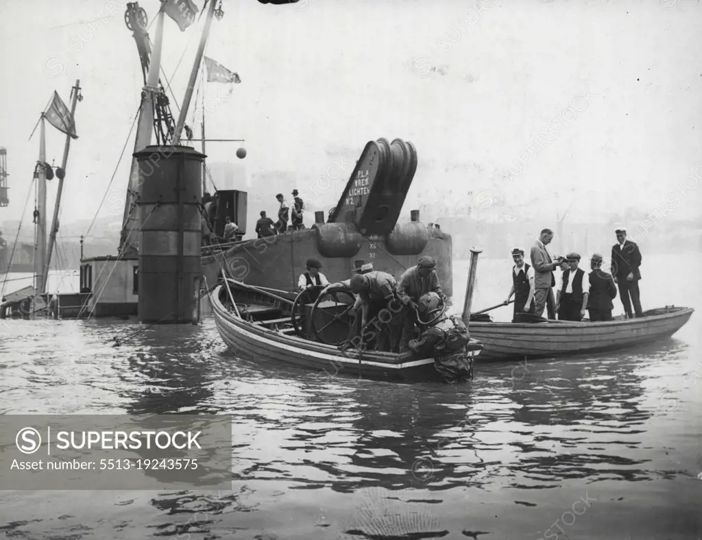 Ship Sunk In The Thames -- A British coastal vessel built only this year and loaded with iron and steel sank in a few minutes after Collision with an overseas liner in the Thames at Gallions reach. The wrecked vessel caused a great hold up of shipping being right in the path of the trade channel.The wrecked vessel with divers and wreck lighters ***** work.  September 23, 1935. (Photo by Universal Pictorial Press & Agency)