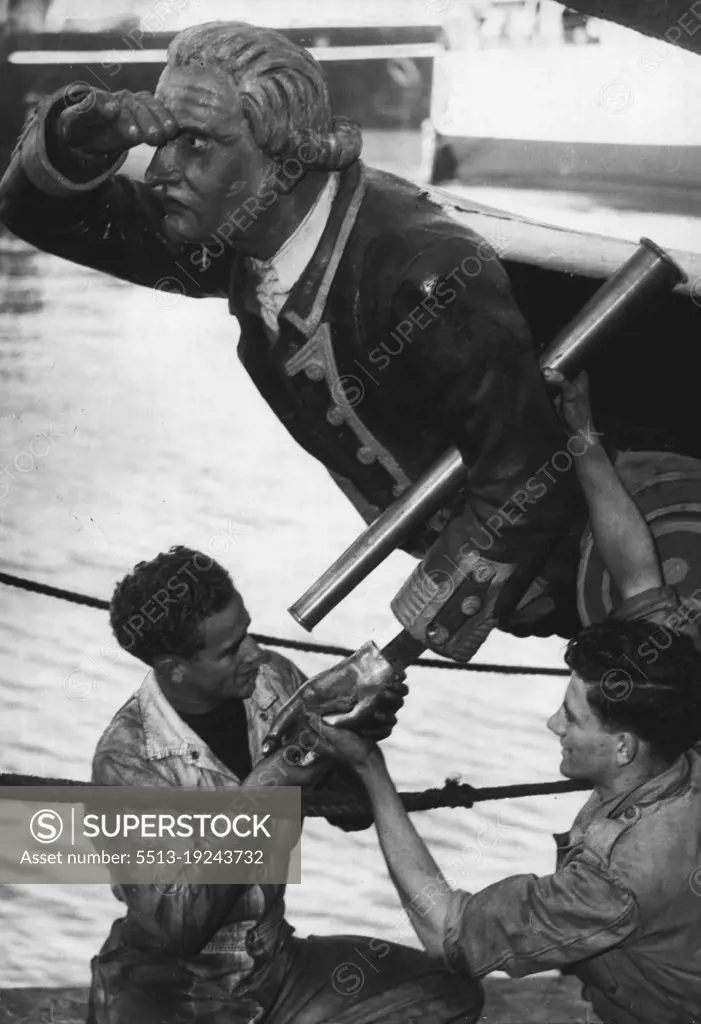 The pilot steamer "Captain Cook" is undergoing a route check-up at Mort's Dock.Russ Howe (left) and John Bourne, apprentice engineers, are shown refitting the left hand and telescope to the steamer's figure head. June 13, 1947. (Photo by Frank Albert Charles Burke/Fairfax Media).