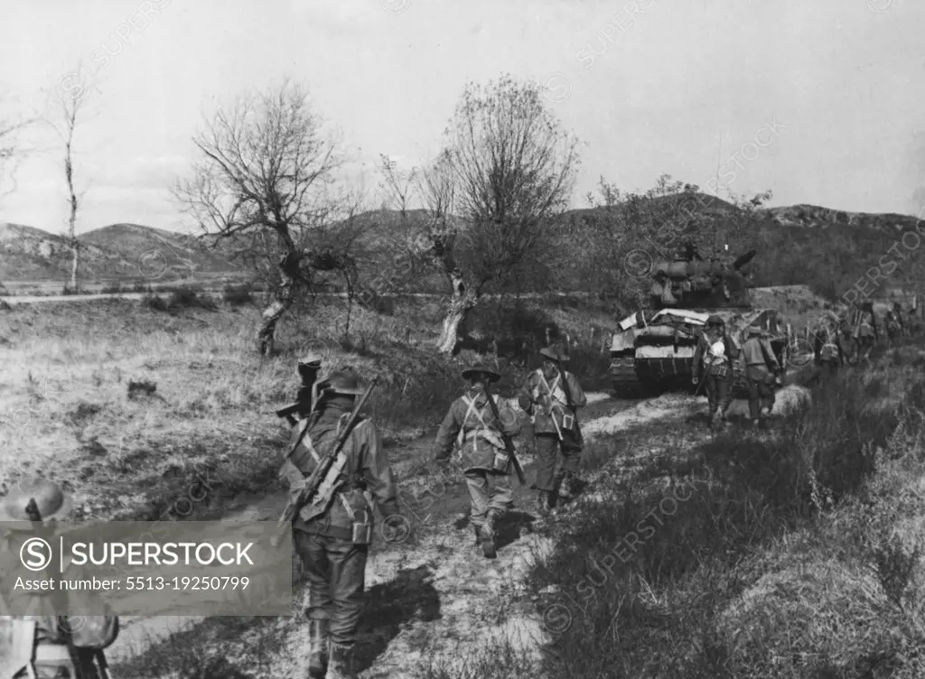 There men C Coy of 3 Battalion, Royal Australian Regiment, celebrated Melbourne Cup Day by advancing against the North Koreans under the wing of escorting United States tanks. November 22, 1950. (Photo by Public Relations Section, HQ BCOF Japan).