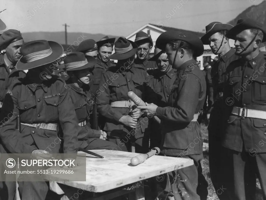 A Bazooka projectile is not large as missiles go, but it carries a mighty wallop in its nose. These reinforcements for Third Battalion, Royal Australian Regiment, are learning the drill about the bazooka at a BCOF base camp before moving over to join their mates in the Korean fighting. All these men have heard about the bazooka's tank-busting properties. Now they are waiting their chance to test them in action against the reds. November 17, 1950.