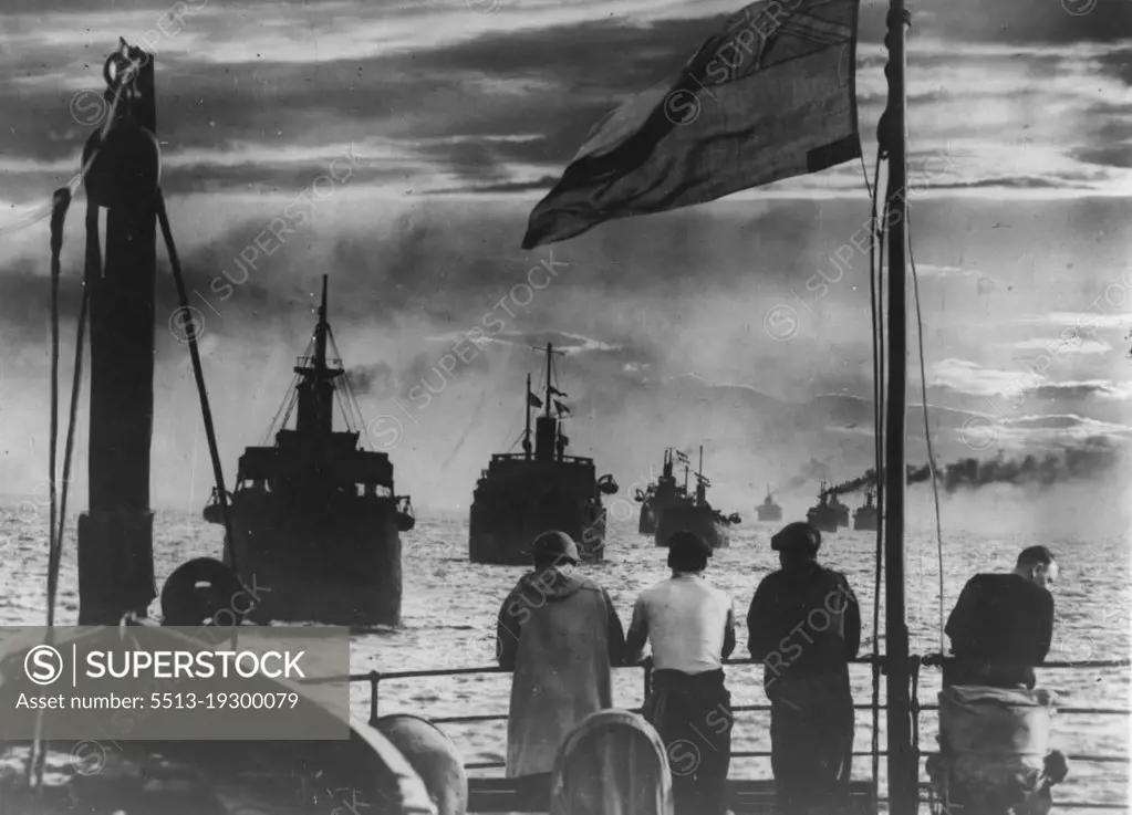 Food Convoy! -- A striking picture taken from one of 24 vessels which were under convoy along the East Coast of Britain, as the sun was setting on the food fleet, with look-out men and a naval gunner keeping watch. Other ships, some camouflaged, sailed astern. September 14, 1940. (Photo by Keystone).