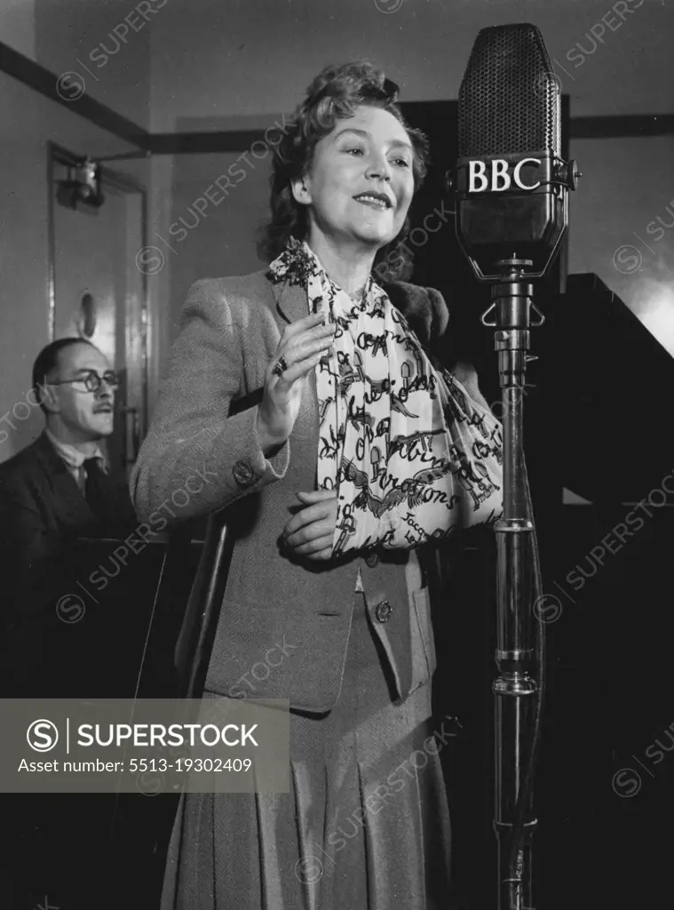 Annette Mills returns to broadcast a programme of her own songs in the BBC Forces Programme, on November 3rd, 1943. She is accompanied at the piano by Rex Burrows (in the background).Annette Mills, the dancer who introduced the Charleston to Great Britain, and the composer of 'Boomps-a-daisy', has been in hospital for a year following a serious motor accident which occurred while she was driving between two R.A.F. stations to entertain the airmen. She suffered eight fractures, and is still dependent upon crutches and a sling. On November 4th, the day after this broadcast, she returns to hospital for what she hopes will be her final operation. November 03, 1943. (Photo by BBC).