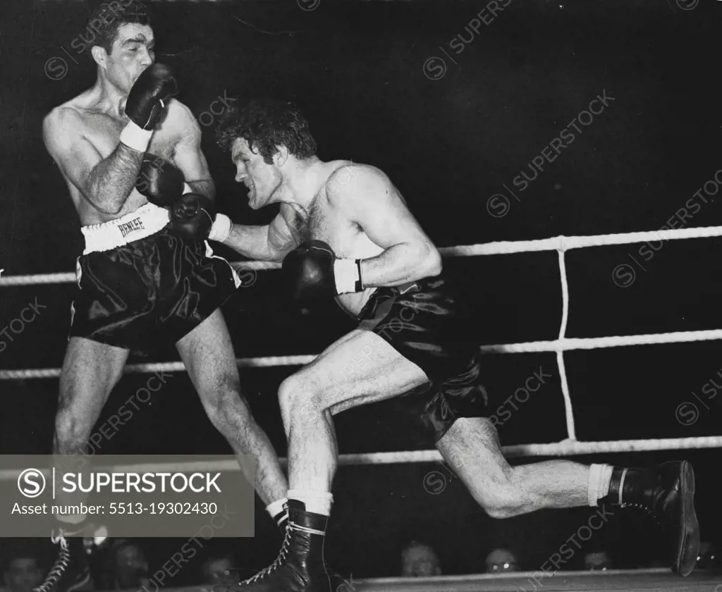 Freddie Mills V Joey Maxim...World light heavy-weight title fight at earls court tonight. Round 9, of the Big Fight. It is nearly the end but there is no sign of weakness in Mills as he throws a right to Maxim's stomach, while the American blocks. January 24, 1950. (Photo by Paul Popper Ltd.).