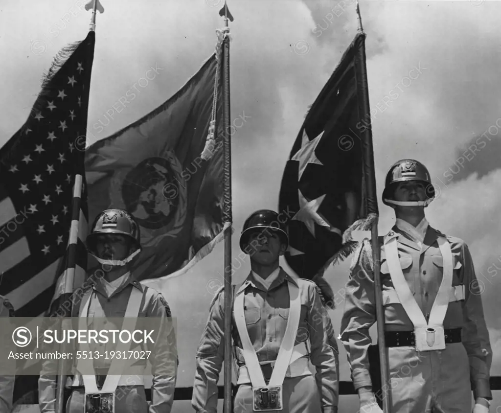 The blue and white flag of the United Nations flies between the United States flag (at left) and General Douglas MacArthur's five-star general's flag after it was presented to the general at his head-quarters in Tokyo, Japan.General MacArthur is Commander-in-Chief of the United States Amy. Far East Command, and Commanding General for the unified United Nations military forces assisting the Republic of Korea in defense against the North Korean Communist invasion. July 14, 1950. (Photo by United States Information Service).