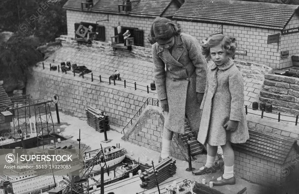 Little Princess Visit Model Village - Princess Elizabeth and Princess Margaret Rose interested in the model docks and shipping.Princess Elizabeth and Princess Margaret Rose today paid a visit to the model village of "Bekonscot," at Beaconsfield, Buckinghamshire. April 15, 1936. (Photo by Topical Press).