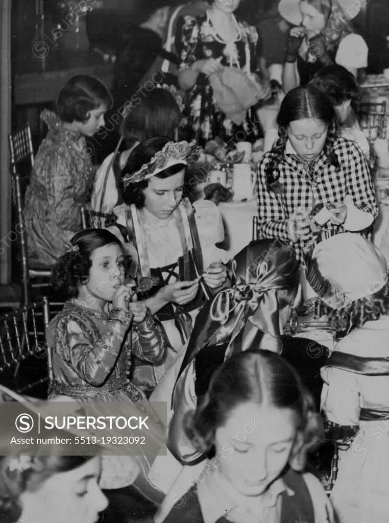 Princess Margaret Blows a "Squeaker" Attends Fancy Dress Party with Sister - Princess Margaret Rose blows a "squeaker" at the party.Background (left) is Princess Elizabeth.Princess Elizabeth and Princess Margaret Rose attended a children's fancy party at the home of Viscountess Astor in St. James' Square, London.Both the Princess were historical costumes of the Elizabeth an period.They mixed freely with the 70 other young guests, who included the children of the American Ambassador, inflated balloons, joined in the games and amused themselves enormously. March 07, 1939.