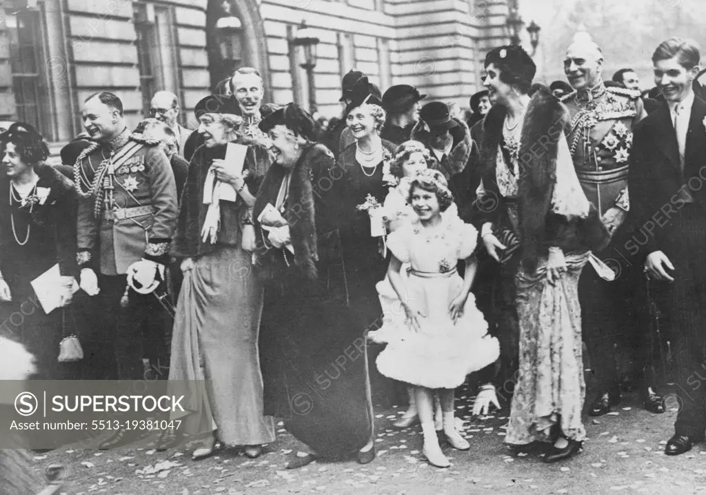 The Royal Wedding Guests Assembled In The Forscourt Of Buckingham Palace, To Bed Farewell To The Duke And Duchess Of Gloucester As They Drove To St. Pancras Station En Route For Their Honymmon -- A happy group watching the bridges and bridegroom leave the Palace.L to R. Lady Maud Carnegie, the Marquess of Cambridge, Princess Marie Louise (behind whom is Lord Carnegie), Princess Helena Victoria, the Countess of Athlane, Princess Elizabeth and behind her, Lady Mary Cambridge, Lady Patricia Ramsay, the Earl of Athlone, and Mr. A. Ramsay. November 6, 1935. (Photo by Sports & General Press Agency Limited).