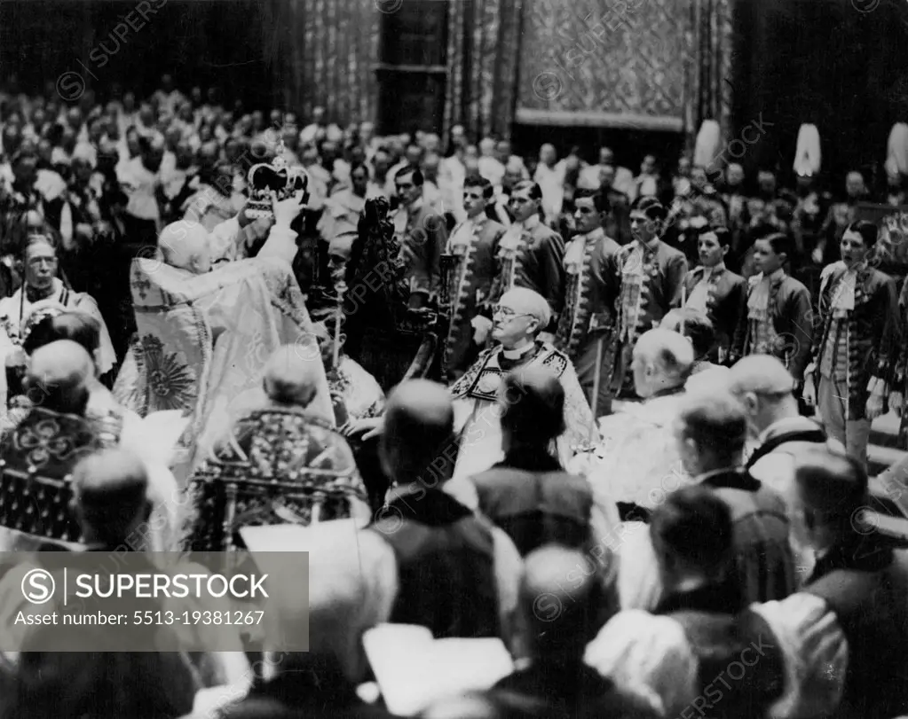 The moment of majesty as King George VI was crowned King and Emperor at Westminster Abbey on May 12, 1937. The Archbishop of Canterbury, taking the Crown of St. Edward from the Dean of Westminster, placed it reverently upon the King's head. As he did so the deep silence in the Abbey was broken with the loud and repeated cries of "God Save the King." March 17, 1953. (Photo by Daily Mirror).